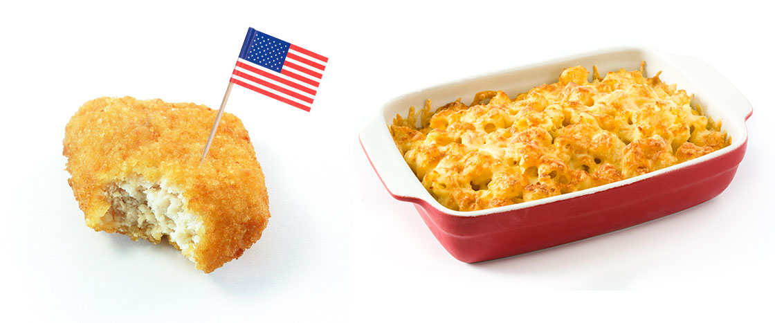 A chicken nugget with a flag in it and mac and cheese