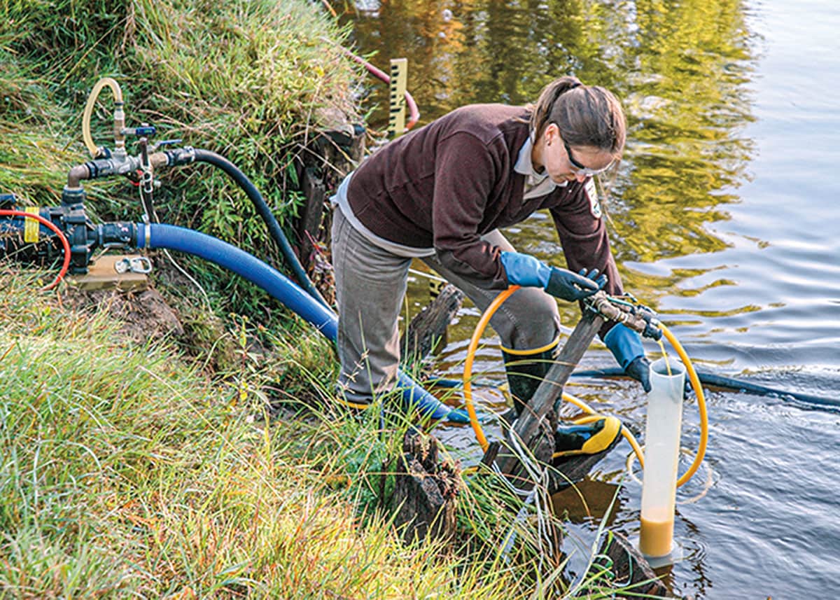 A scientist using a many tubed machines to treat the lake for lamprey