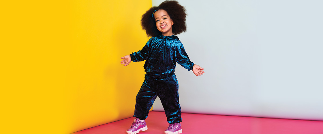 Photo of a person posing against a colorful background