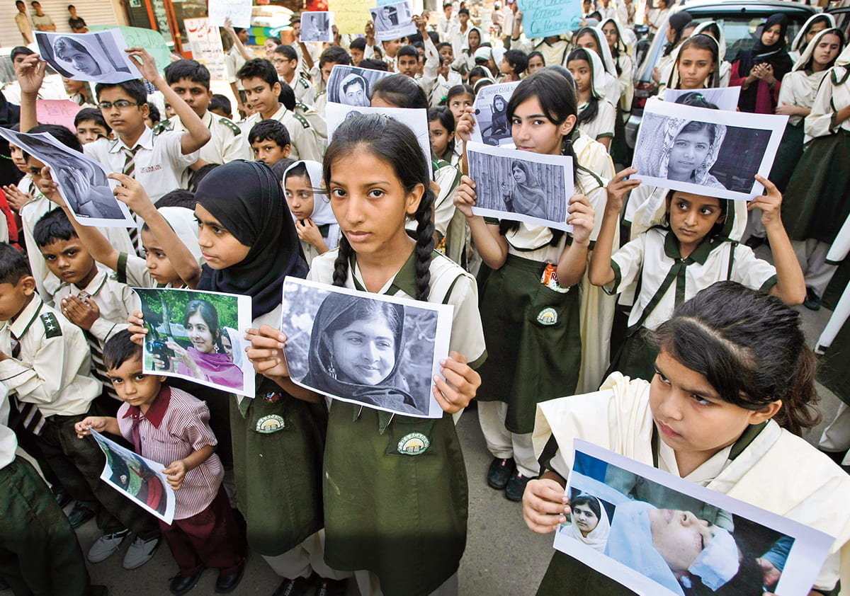 Photo of students all showing an image of Malala
